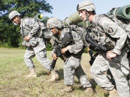 A group of soldiers marching with army assault packs on their backs