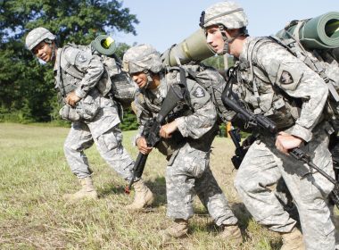 A group of soldiers marching with army assault packs on their backs