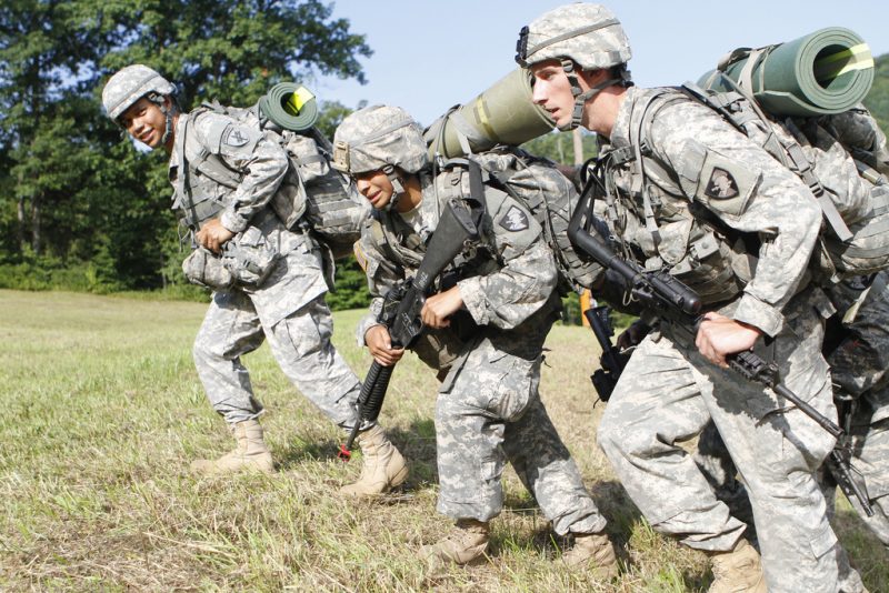 A group of soldiers marching with army assault packs on their backs