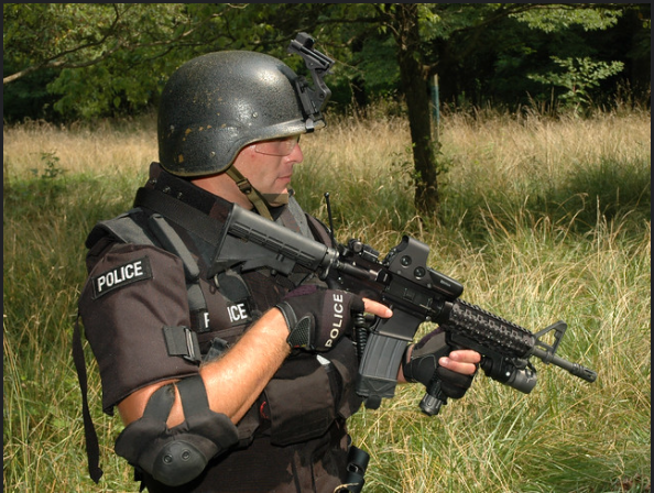 Best Two-Point Tactical Shotgun Slings A photo of an American officer posing with his M4 Commando strapped on a Vector one-point sling