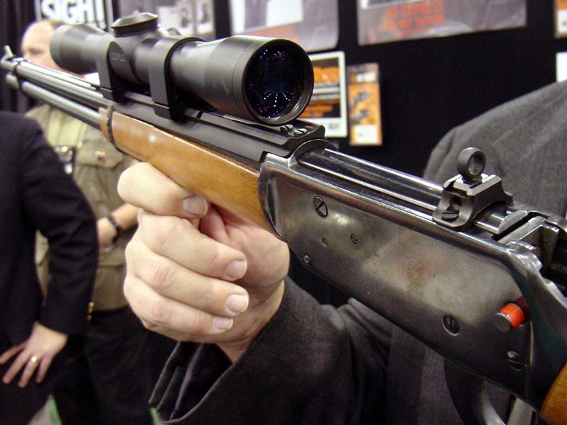 A 30-30 scope mounted on top of a lever action rifle