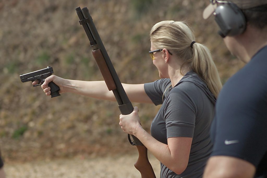 Woman ready to shoot - Shotgun or pistol?