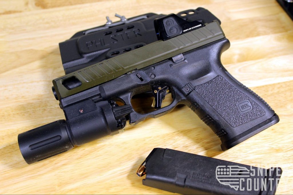 Custom Glock 19 with a Phlster holster, Modlite WML, and Holosun 407 GR.