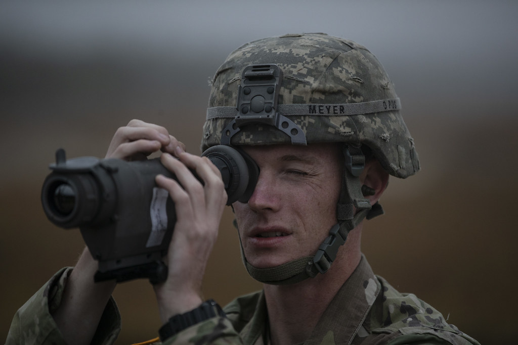 A close-up shot of an American Soldier using a thermal scope.