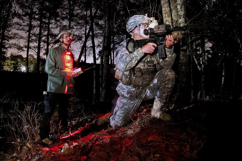 A close-up image of two American soldiers aiming to shoot a game while using a cheap thermal scope.